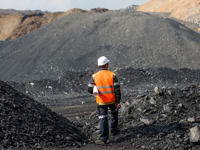 Coal mining in an open pit - Worker is looking on the huge open pit