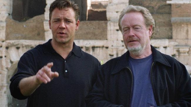 Director Ridley Scott and Russell Crowe pose in front of Rome's Colosseum.
