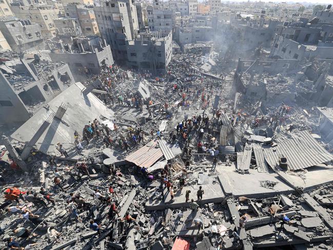 People search for survivors and the bodies of victims through the rubble of buildings destroyed during Israeli bombardment, in Khan Yunis in the southern Gaza Strip. Picture: AFP