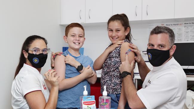 Qualified Covid-19 vaccinator and pharmacist Georgina Twomey with her son Archer Twomey, 8, daughter Scarlett Twomey, 10 and Trent Twomey at their Alive pharmacy in Westcourt. Picture: Brendan Radke