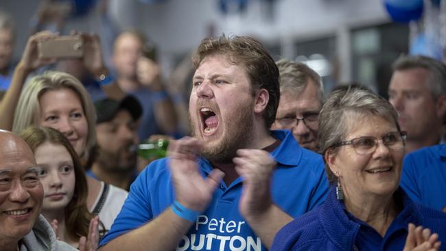 A Peter Dutton supporter cheers his return at his election night party north of Brisbane.