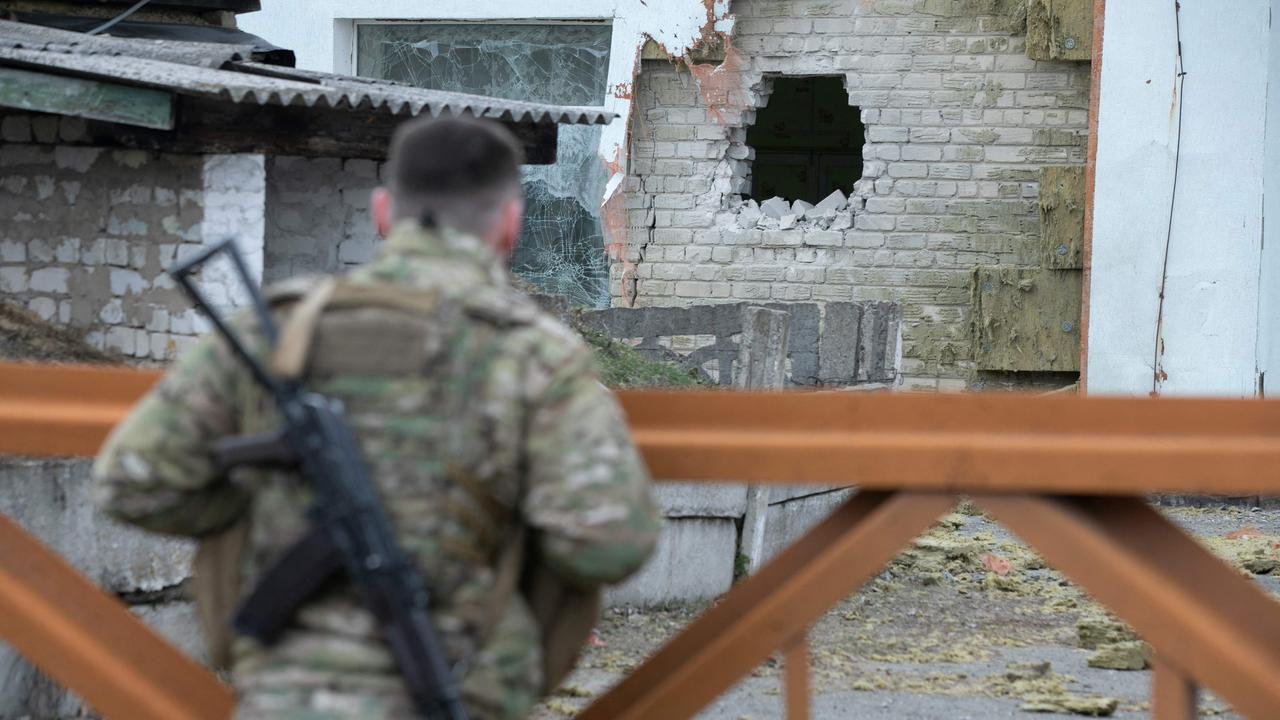 A Ukrainian soldier looks at debris after the reported shelling of a kindergarten. Picture: Aleksey Filippov/AFP