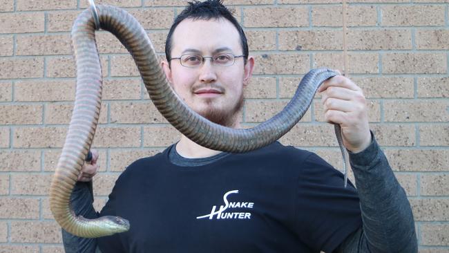 Mr Pelley with a Lowland Copperhead snake. Picture: Supplied