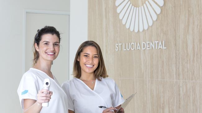 Manager and CEO Raquelle Quinn with one of the infrared thermometers used on patients when they arrive, with receptionist Serena Lovell. Picture: Renae Droop