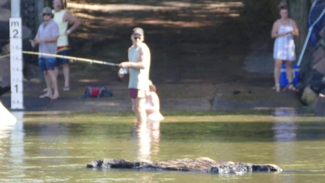 Croc bait ... a woman can be seen sitting in the water at Cahills Crossing while a man stands shin deep in the water. Picture: Charlotte Nansen
