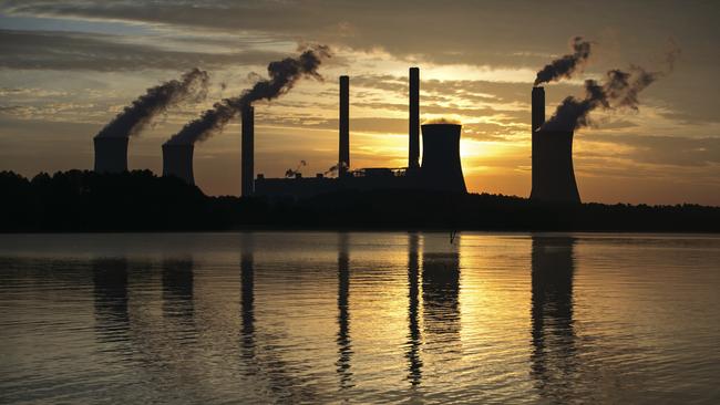 The coal-fired Plant Scherer, one of the nation's top carbon dioxide emitters, stands in the distance in Juliette, Ga., Saturday, June, 3, 2017. U.S. President Donald Trump declared Thursday he was pulling the U.S. from the landmark Paris climate agreement, striking a major blow to worldwide efforts to combat global warming and distancing the country from its closest allies abroad. (AP Photo/Branden Camp)