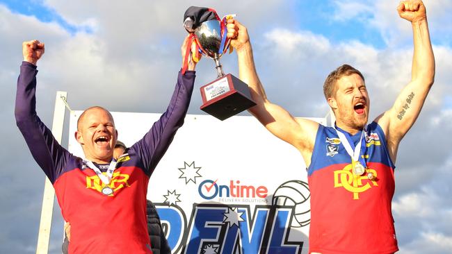 Diggers Rest coach Jamie Lobb and captain Tom Gleeson raise the premiership cup. Picture: Aaron Cook