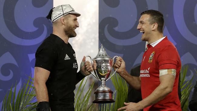 New Zealand captain Kieran Read and Lions captain Sam Warburton joke as they hold the trophy.