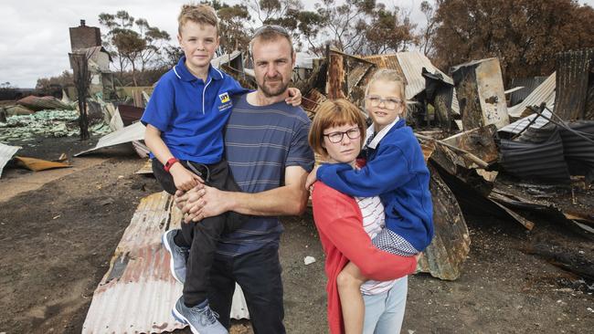 The Buck family at their burnt out property on Kangaroo Island. Picture: SIMON CROSS