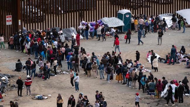 Migrants wait to be processed by US authorities on the US side of the US-Mexico border. Picture: AFP