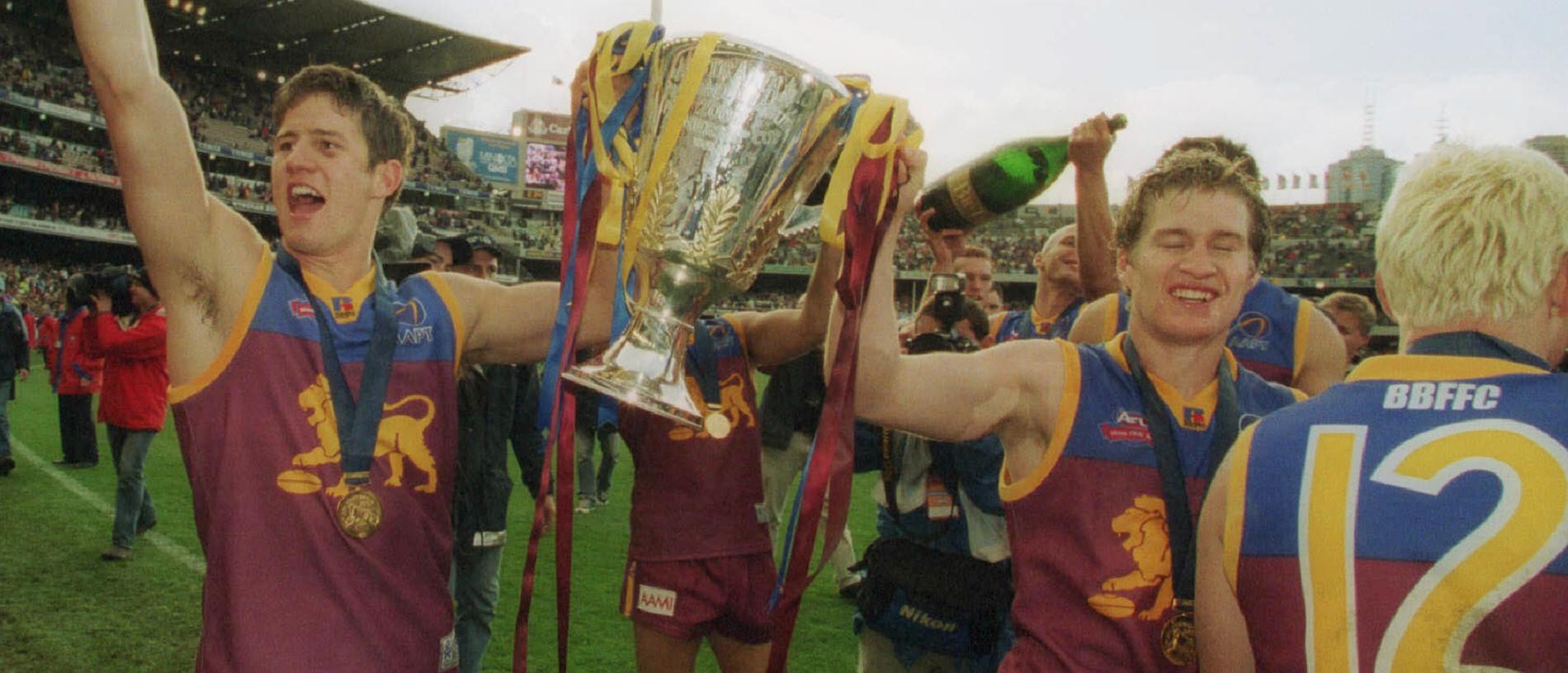 28/09/2002. Aaron Shattock and Luke Power with premiership cup. 2002 Grand Final. Brisbane Lions v Collingwood. MCG.