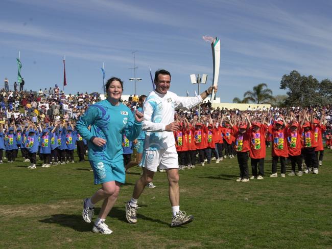 Pat Farmer runs into Campbelltown Sports Stadium during Penrith to Bowral leg of Sydney 2000 Olympic Torch Relay. Picture: Robert McKell