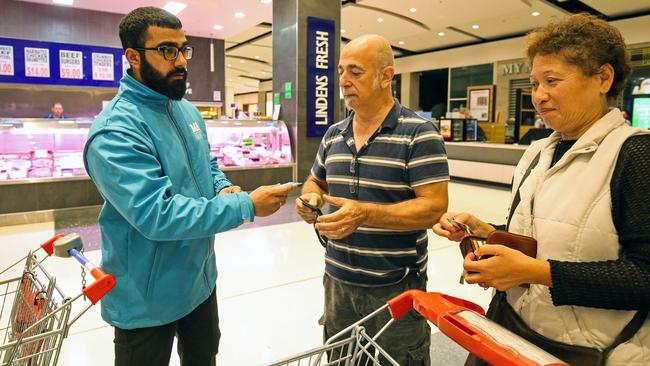 Security check customers eligibility during the first Coles Community Hour at Coles Southland. Picture: Martin Keep/Getty Images