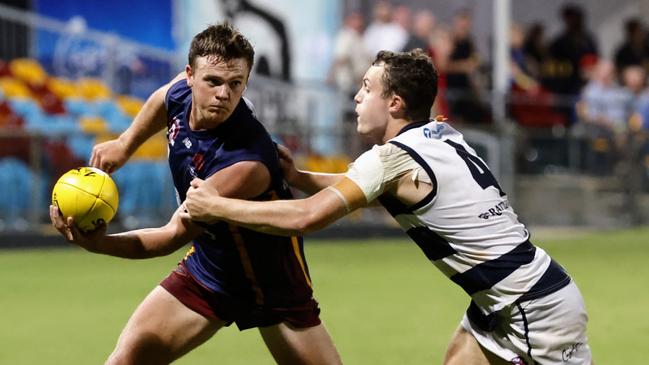 Lions' Tom Lindenmayer escapes the grip of Crocs' Daniel Davidson in the AFL Cairns Premiership men's grand final match between the Cairns City Lions and the Port Douglas Crocs, held at Cazalys Stadium, Manunda. Picture: Brendan Radke