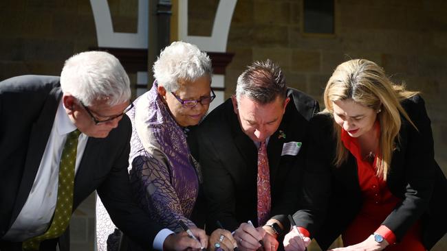 Queensland Premier Annastacia Palaszczuk, Minister for Aboriginal and Torres Strait Islander Partnerships Craig Crawford, Treaty Advancement Committee Co-Chair Dr Jackie Huggins and fellow Co-Chair Mick Gooda pose after signing the Statement of Commitment to the Path to Treaty between the state and First Nations people, at Parliament House in Brisbane.