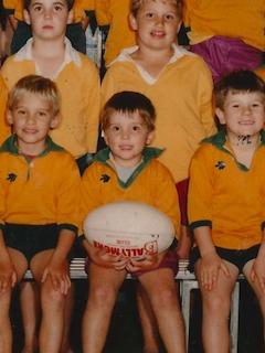 Thomas holding the ball as a 4-year-old in the 1989 Under 7’s team.