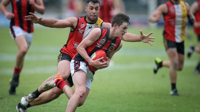 Nick Favretto lays a tackle on ROC’s Anthony McCarthy. Picture: Dean Martin