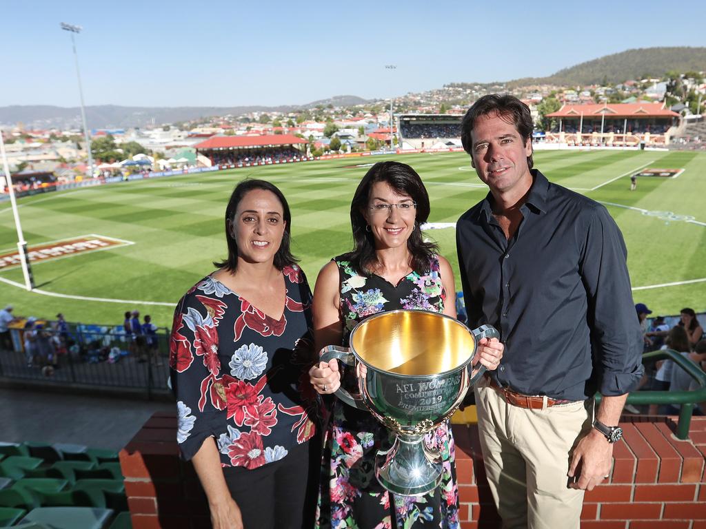 AFLW chief executive Nicole Livingstone, left, Tasmanian Minister for Sport and Recreation, Jacquie Petrusma, and AFL chief executive Gillion McLachlan holding the AFLW premiership cup at the match between North Melbourne and Carlton at North Hobart Oval. Picture: LUKE BOWDEN