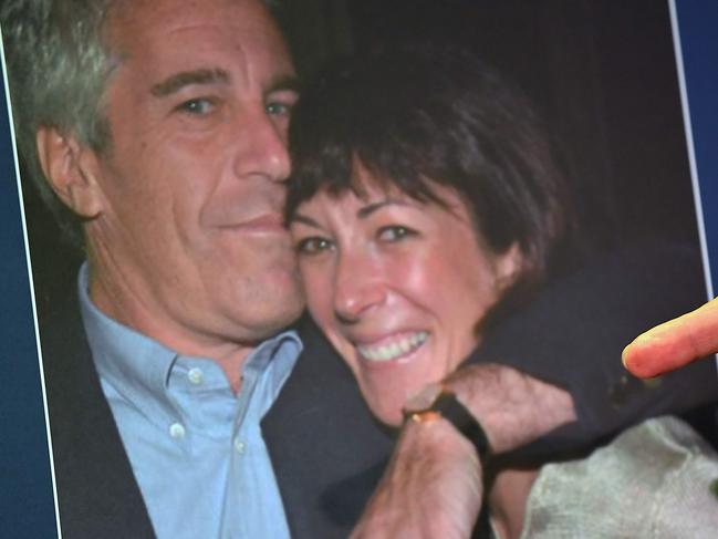 (FILES) In this file photo taken on July 2, 2020 a photo of Ghislaine Maxwell and Jeffrey Epstein is seen as acting US Attorney for the Southern District of New York, Audrey Strauss, announces charges against Maxwell during a press conference in New York City. - US President Donald Trump said on July 21, 2020 that he had not been following closely Ghislaine Maxwell's arrest on sex trafficking minors for Jeffrey Epstein but that he wished her well. (Photo by Johannes EISELE / AFP)