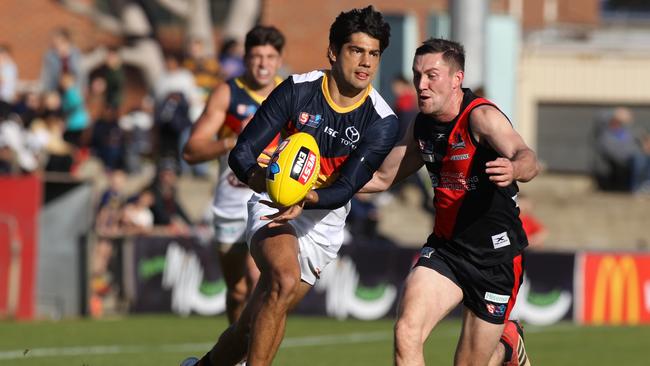 Adelaide's Shane McAdam breaks away from West's Jack Evans. Picture: AAP Image/Dean Martin