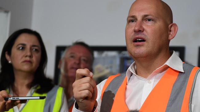 Queensland Premier Annastacia Palaszczuk (left) watches Treasurer Curtis Pitt speaking at a press conference during a visit to a construction site in Cairns, Monday, November 20, 2017. Ms Palaszczuk is on the campaign trail ahead of the November 25 state election. (AAP Image/Dan Peled) NO ARCHIVING