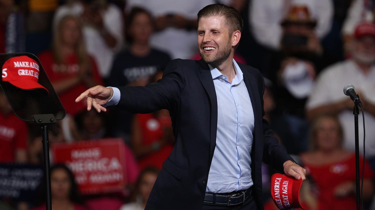 Eric Trump tosses a hat into the crowd at a campaign rally for his father. Picture: Getty Images