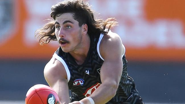 ADELAIDE, AUSTRALIA - FEBRUARY 13: Lachlan Jones of Port Adelaide handballs during the Port Power AFL trial match at Alberton Oval on February 13, 2021 in Adelaide, Australia. (Photo by Mark Brake/Getty Images)