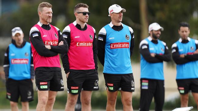 Nathan Buckley and his coaching team keeps an eye on training.