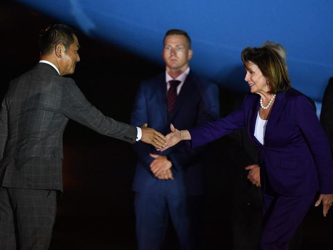 US House Speaker Nancy Pelosi (R) shakes hands with Japan's Vice Foreign Minister Kiyoshi Odawara (L) upon her arrival at Yokota Air Base in Fussa, Tokyo prefecture on the last leg of her Asian tour. Picture: AFP