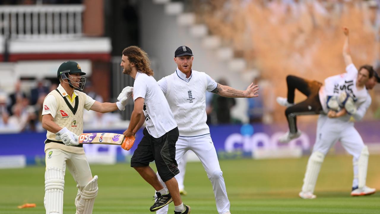 Ben Stokes and David Warner attempt to stop a "Just Stop Oil" protester as Jonny Bairstow tackles another pitch invader. Picture: Getty