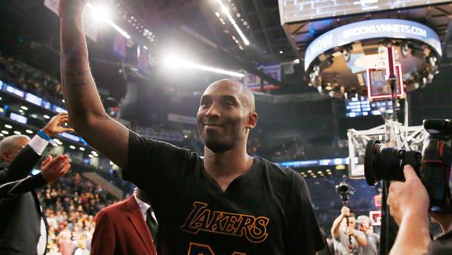 Kobe Bryant of the Los Angeles Lakers waves to the crowd after defeating the Brooklyn Nets 104-98 at the Barclays Center.