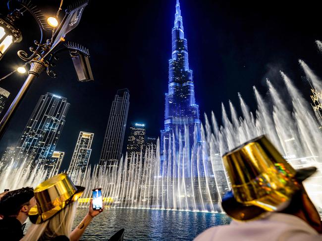 Revellers stand by the fountain near Burj Khalifa, the world’s tallest building, for New Year's Eve celebrations in Dubai. Picture: AFP