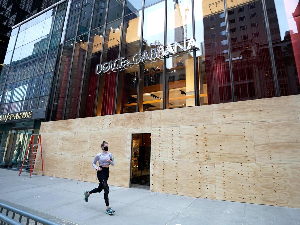 The grand entrance to Dolce &amp; Gabbana is now a door in the plywood. Picture: Timothy A. Clary/AFP