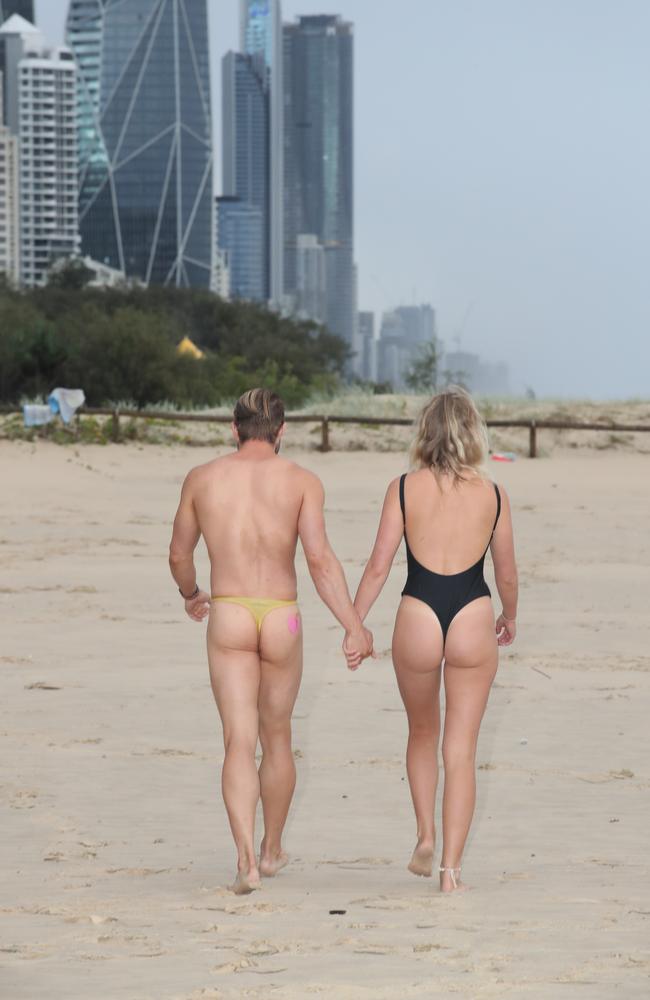 Steven Cragg and Chloe Richards were among about 20 in Broadbeach in honour of #freedomofpeach, with women in skimpy swimwear and a smattering of supportive blokes in budgy smugglers. Picture Glenn Hampson