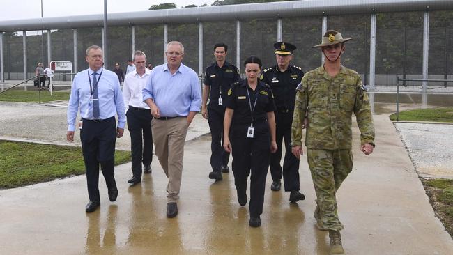 Mr Morrison near the perimeter fence as he tours North West Point Detention Centre. Picture: AAP Image/Lukas Coch