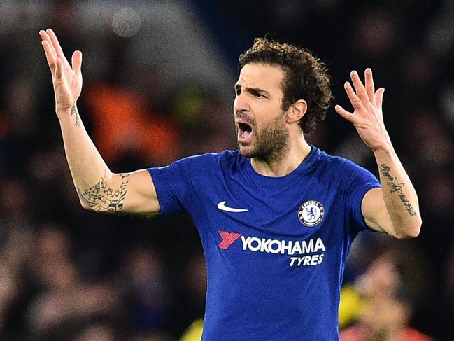 Chelsea's Spanish midfielder Cesc Fabregas gestures to the crowd after Chelsea take the lead during the first leg of the UEFA Champions League round of 16 football match between Chelsea and Barcelona at Stamford Bridge stadium in London on February 20, 2018. / AFP PHOTO / Glyn KIRK