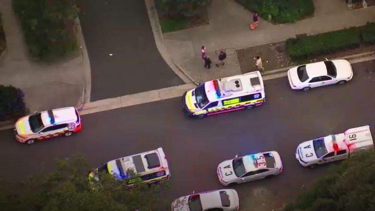 Emergency vehicles line the street outside the scene. Picture: ABC