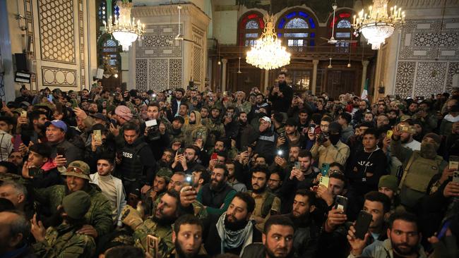 A crowd of supporters listens to a speech by Abu Mohammed al-Jolani the leader of Syria's Islamist Hayat Tahrir al-Sham (HTS) group that headed a lightning rebel offensive snatching Damascus from government control. Picture: Aref Tammawi/AFP