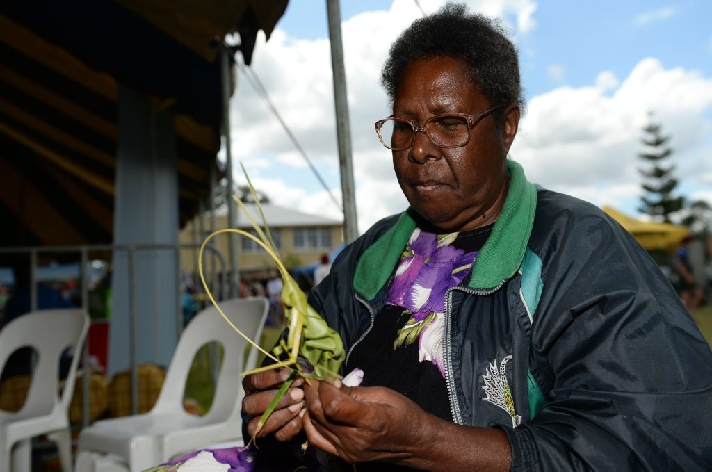 Aunty Patricia from the Saima Co-op making a grasshopper from a palm leaf at the Cultural Festival held at the Heritage Village on Sunday. Photo: Chris Ison / The Morning Bulletin. Picture: Chris Ison