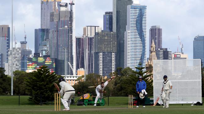 Carlton and Essendon clash in front of the Melbourne skyline.