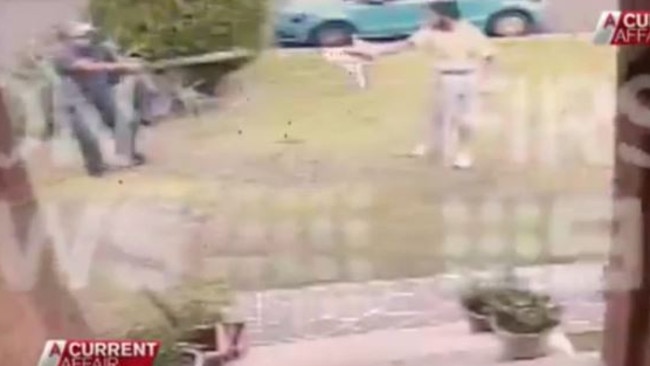 A man armed with what appears to be a large tree branch, bravely confront Khan on the front lawn.