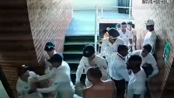 David Warner (far left) had to be restrained by teammates after getting into a heated exchange with South African Quinton De Kock.