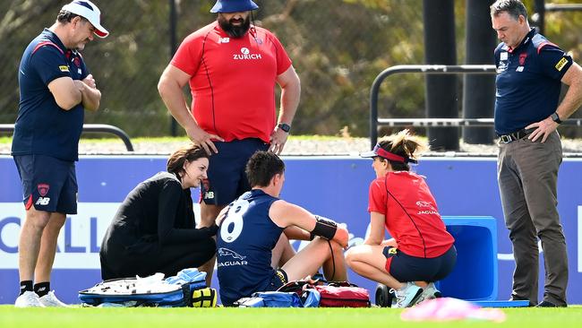 MELBOURNE, AUSTRALIA - DECEMBER 06: Medical staff and Alan Richardson attend to  Jake Lever of the Demons during a Melbourne Demons AFL training session at Casey Fields on December 06, 2021 in Melbourne, Australia. (Photo by Quinn Rooney/Getty Images)