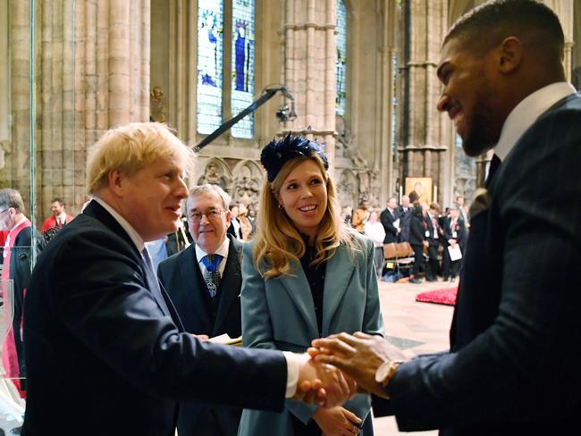 Britain's Prime Minister Boris Johnson and his fiancee partner Carrie Symonds talk with British boxer Anthony Joshua, right, on Monday, March 9. Picture: AP