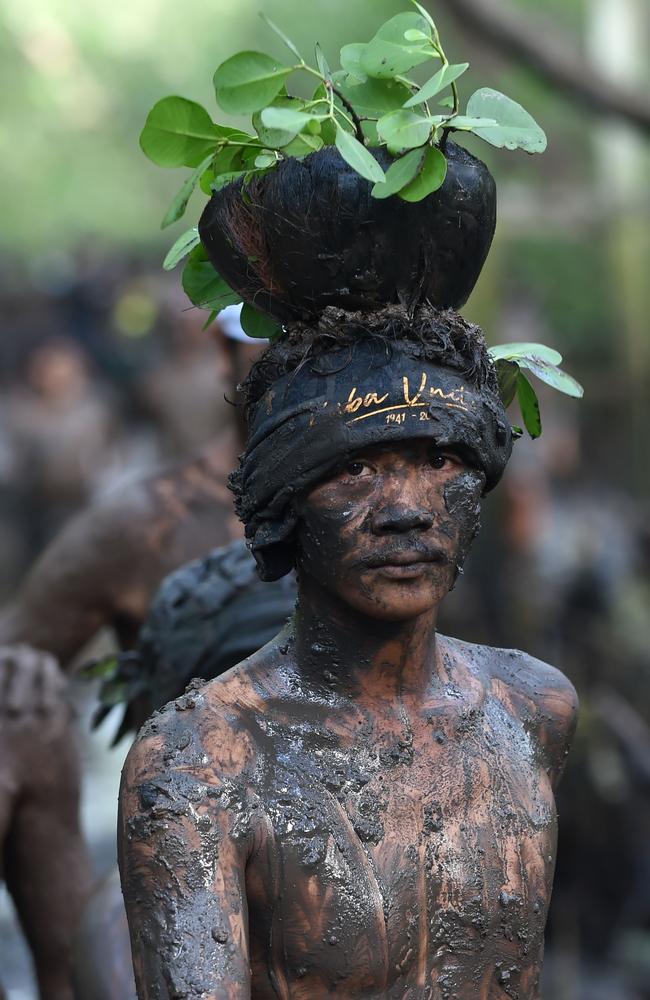 A Balinese man puts mud on his body during a traditional mud bath known as Mebuug-buugan, in Kedonganan village, near Denpasar on March 8, 2019. The Mebuug-buugan is held a day after Nyepi aimed at neutralising bad traits. Picture: Sonny Tumbelaka/AFP