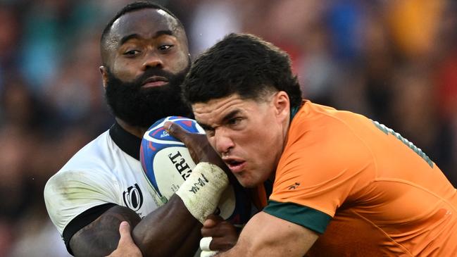 Fiji's left wing Semi Radradra (L) is tackled by Australia's full-back Ben Donaldson (R) during the France 2023 Rugby World Cup Pool C match between Australia and Fiji at Stade Geoffroy-Guichard in Saint-Etienne, south-eastern France on September 17, 2023. (Photo by Olivier CHASSIGNOLE / AFP)