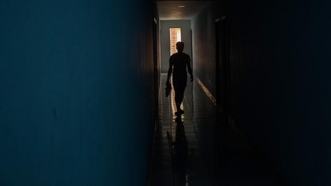 (FILES) In this file photo taken on May 12, 2020 a girl soccer player from the Croix-des-Bouquets Sports Center walks through a dormitory corridor at the center in Croix-des-Bouquets, Haiti. - FIFA on May 25, 2020 suspended the president of Haiti's football federation for 90 days pending an investigation into allegations he sexually abused teenage girls at the national training center. Yves Jean-Bart, 73, categorically denies accusations that he raped several young female footballers at a training facility outside Port-au-Prince over the course of the past five years. (Photo by Pierre Michel Jean / AFP)