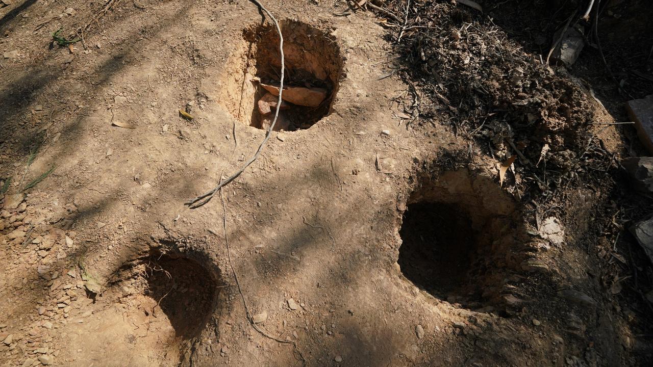 Police have left behind deep holes following their search of the campsite. Picture: Yui Mok/PA Wire/AAP