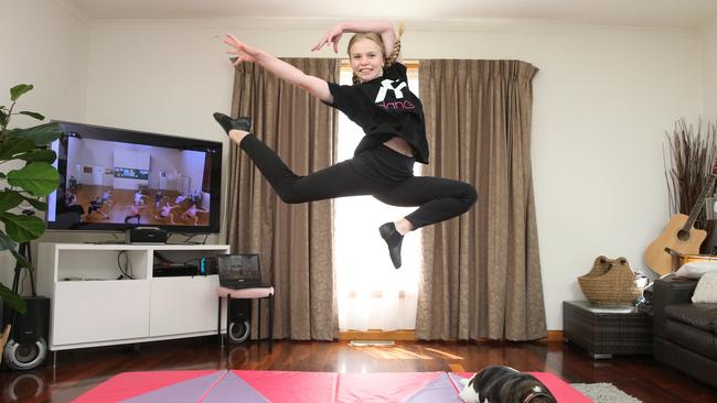 Sophie Hutchinson in her makeshift home dance studio rehearsing as her pet dog Gus watches. Picture: Peter Ristevski