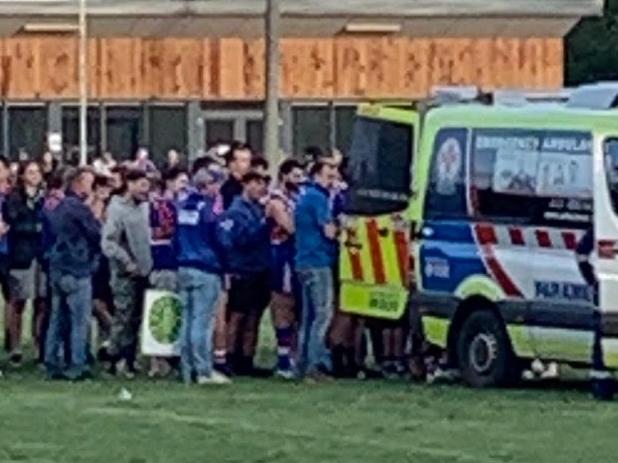 Former Cats player Josh Cowan lay in agony in the middle of Daylesford's football oval with a trainer holding his leg - broken in two places - for 70 minutes, despite a paramedic being available minutes from the ground, the club has alleged. Picture: Supplied